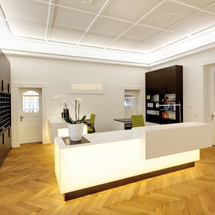 Der beleuchtete Empfangstresen und die Wandschränke sind eine Maßanfertigung. Für bequemes und ergonomisches Arbeiten wurden die Arbeitsstühle AC4 von Vitra gewählt.